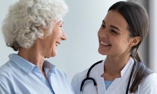 Nurse Practitioner Smiling with Adult Geriatric Patient