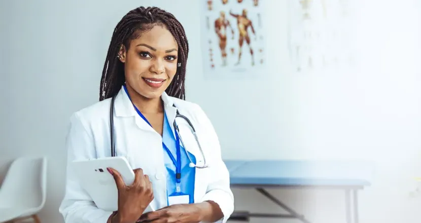 Women's health nurse practitioner with DNP smiling in clinic